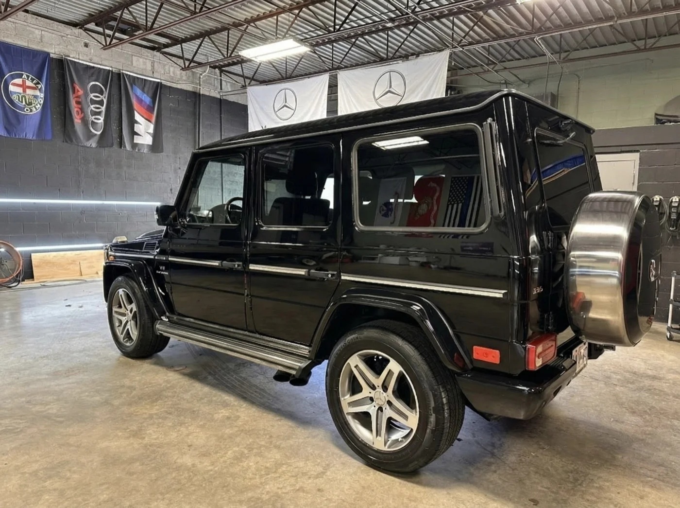 Black SUV under garage lights